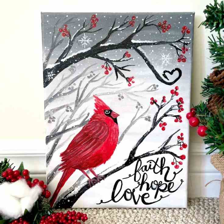 Painting of a cardinal in a snowy scene with the words faith, hope, love