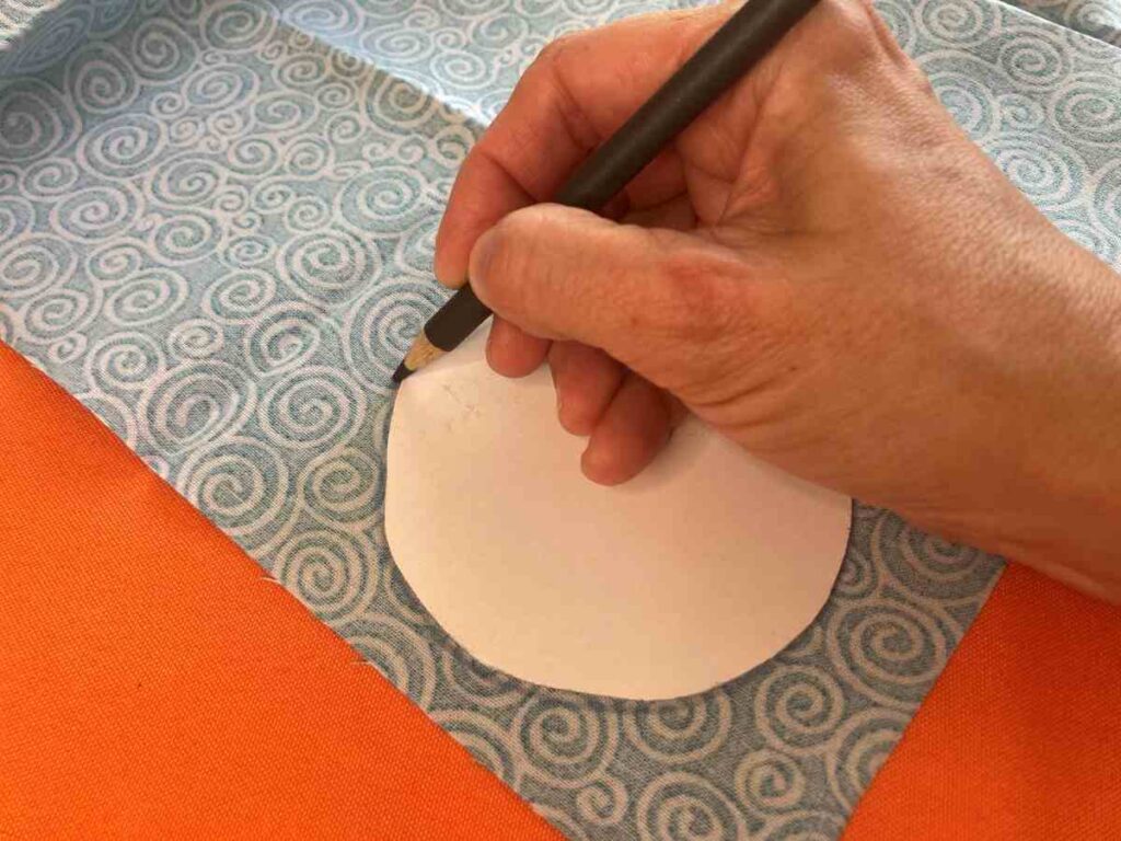 Using the template to trace the ornament onto fabric