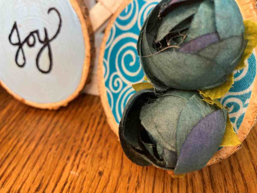 Two decorated wood slice ornaments