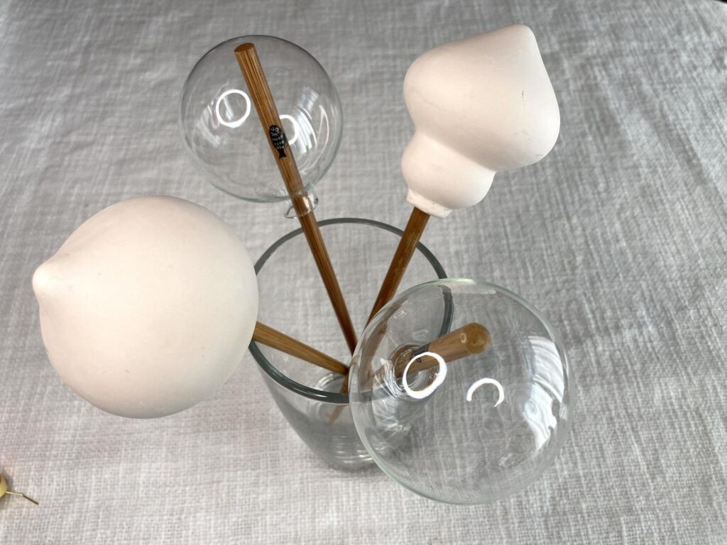Ornaments placed on a skewer in a glass ready to paint