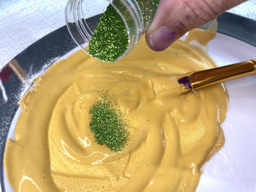 Adding green glitter to yellow paint