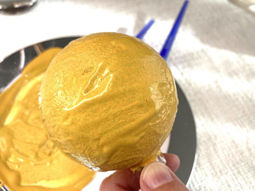 Applying a coat of textured paint to a wooden ornament