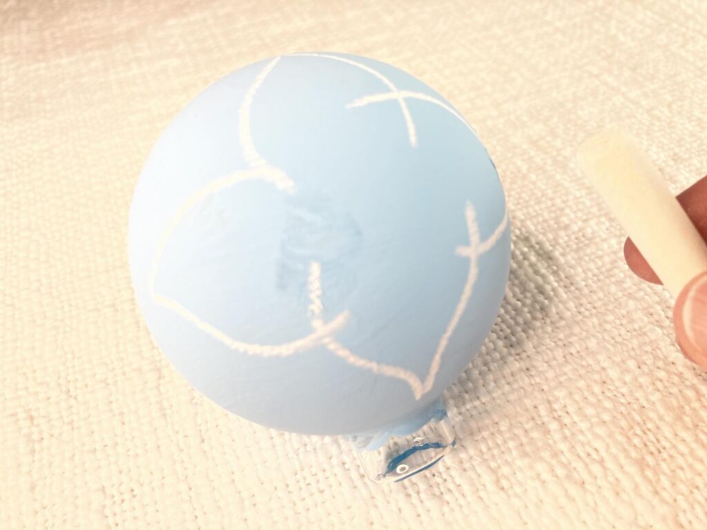 Use chalk to draw a design on your painted ornament