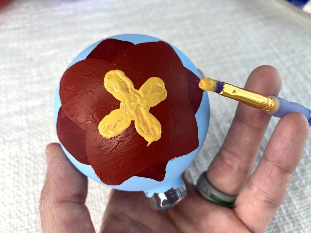 Adding colorful designs to your wooden ornament