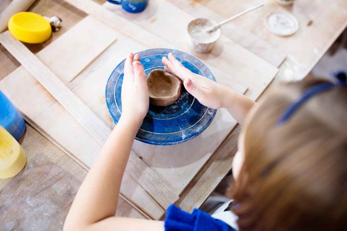 Young girl working on a kids pottery wheel