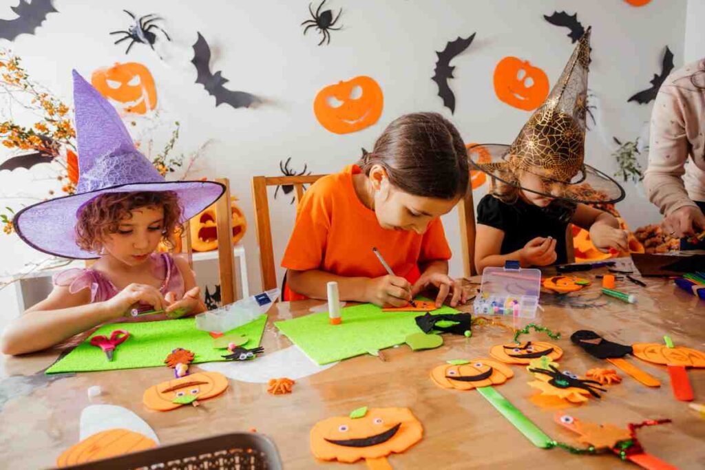 A group of children using halloween craft kits to make decorations