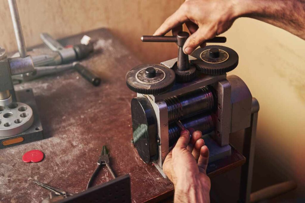 Person using a jewelry rolling mill