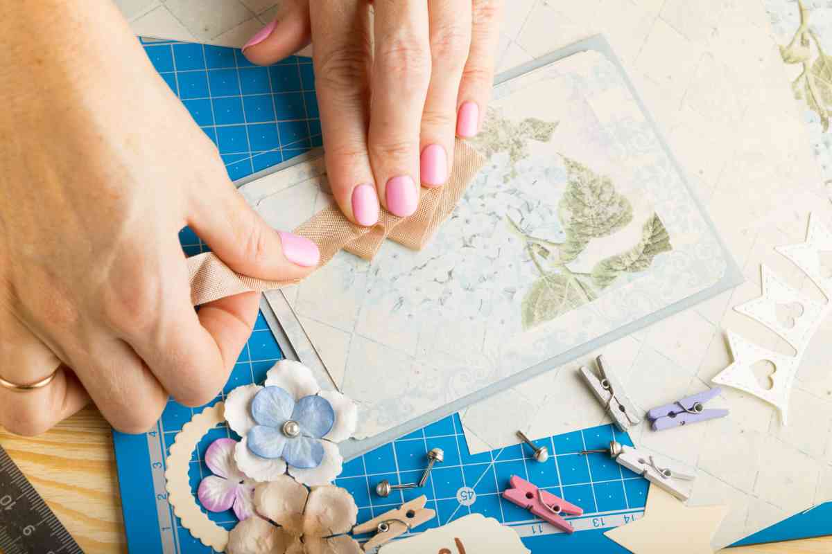 A woman adding elements to a scrapbook page