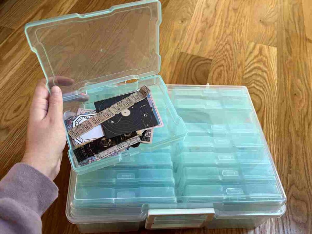 Using a small storage container to organize scrapbooking pieces