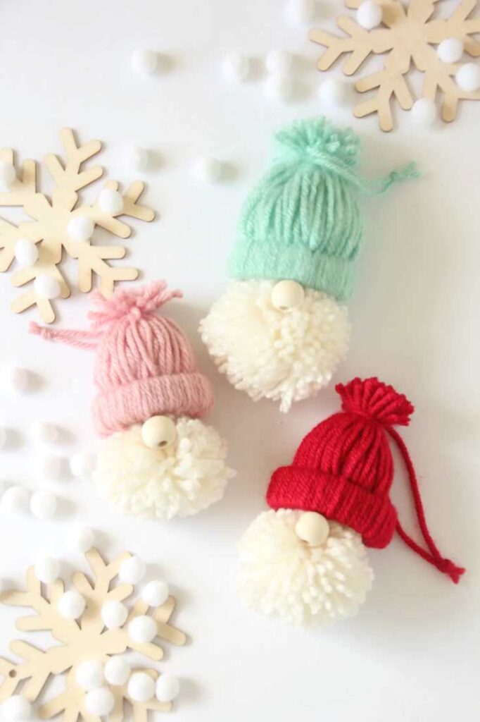 Gnome ornaments made out of toilet paper rolls and yarn