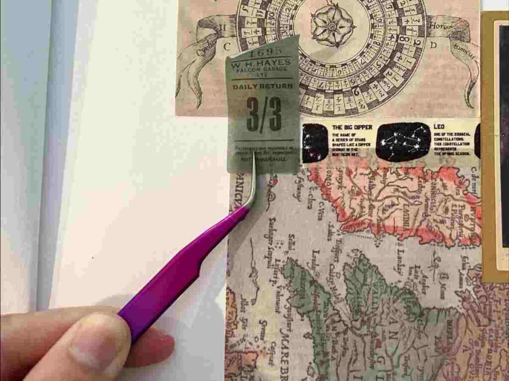 Using craft tweezers to place small items on a scrapbook page